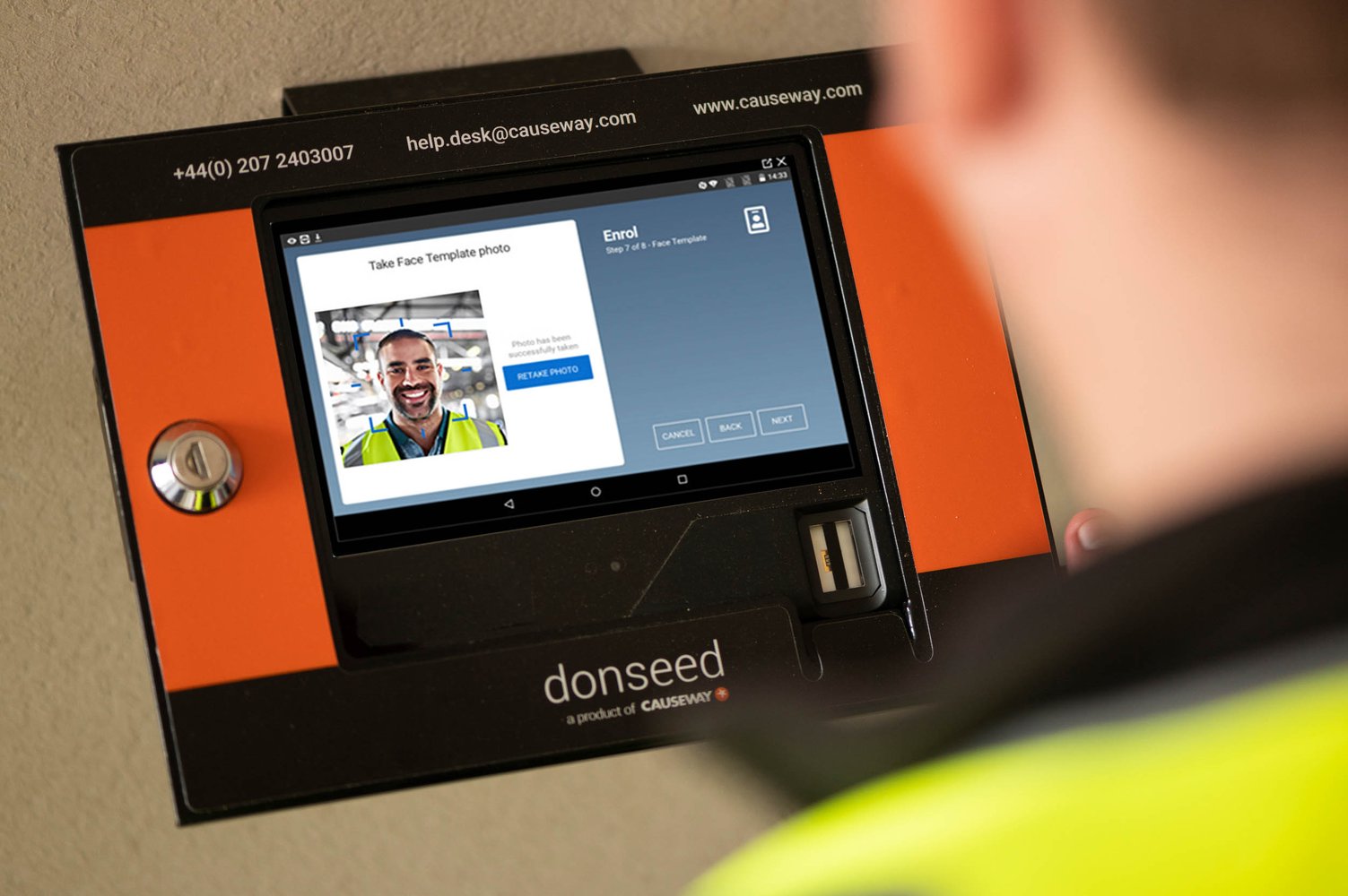Man scans face on construction time and attendance software